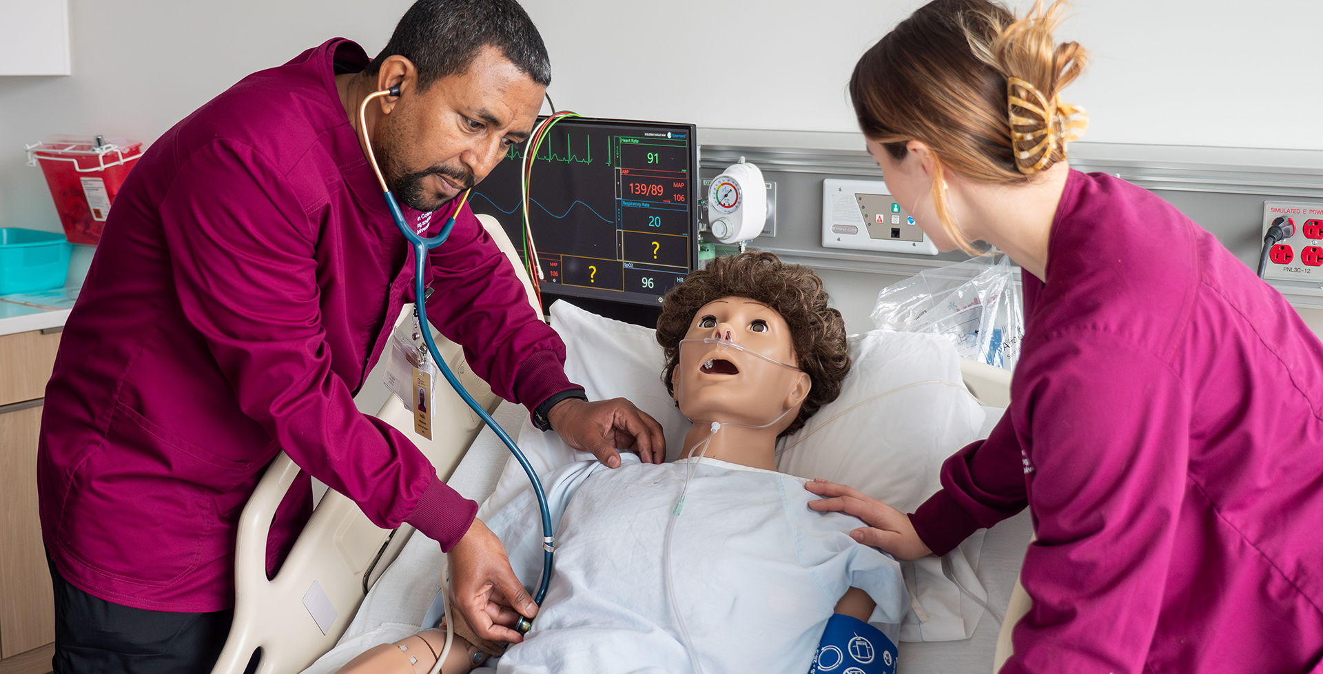 male and female nursing practicing on dummy patient